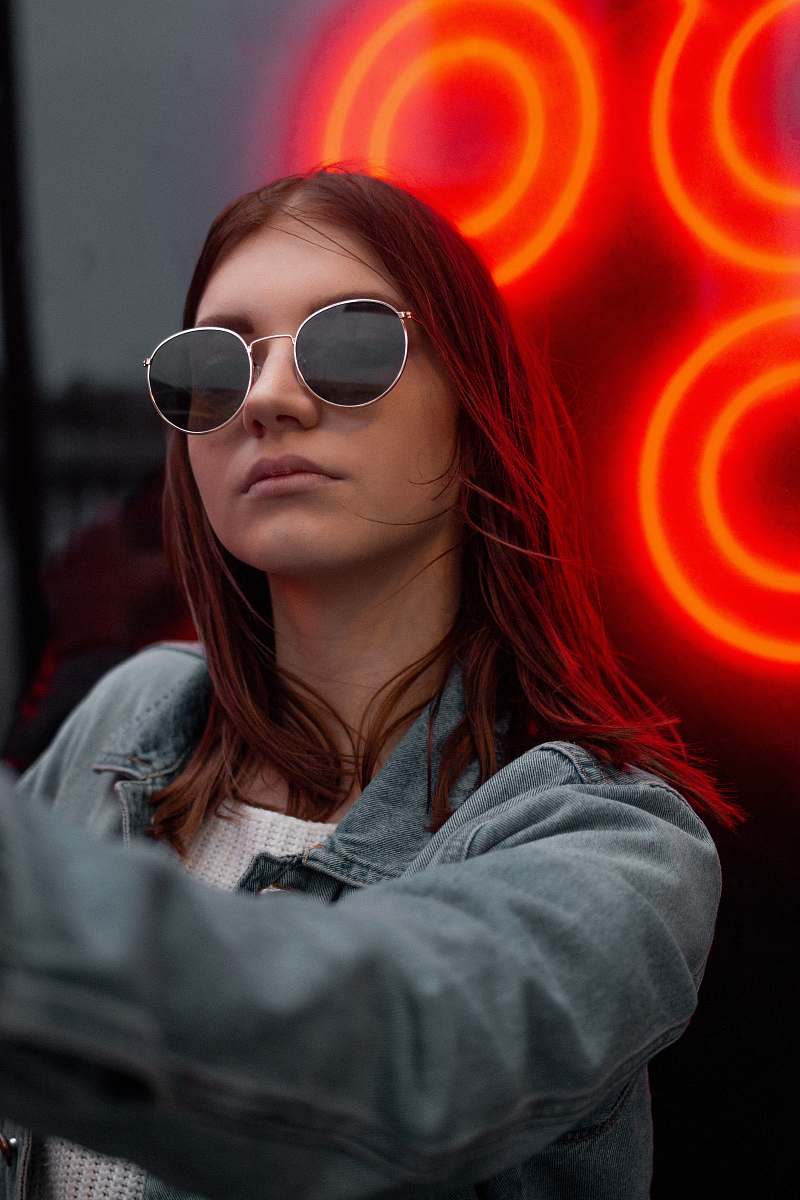 person woman wearing silver-colored framed sunglasses and blue denim collared jacket people