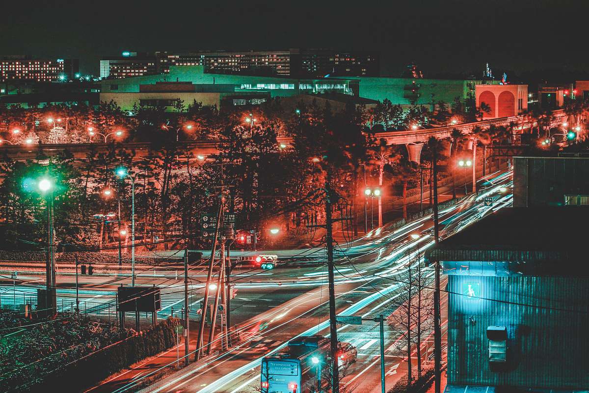city time-lapse photo of lighted buildings at night time urban