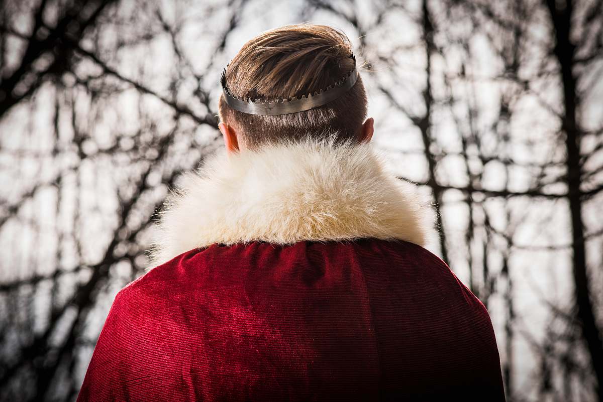 fur person wearing red and white coat trees
