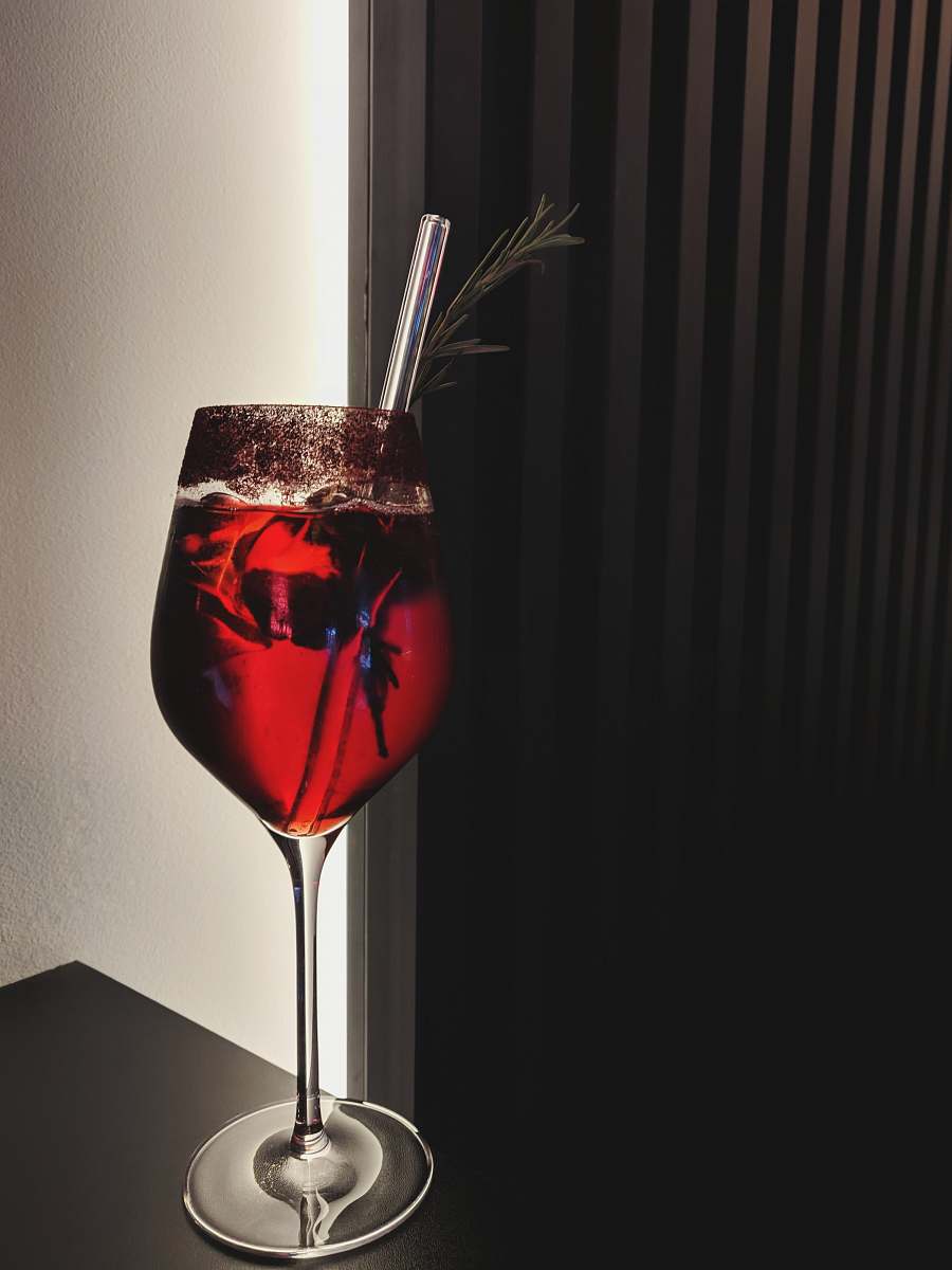 beverage red liquid filled long-stem glass cup on table top wine