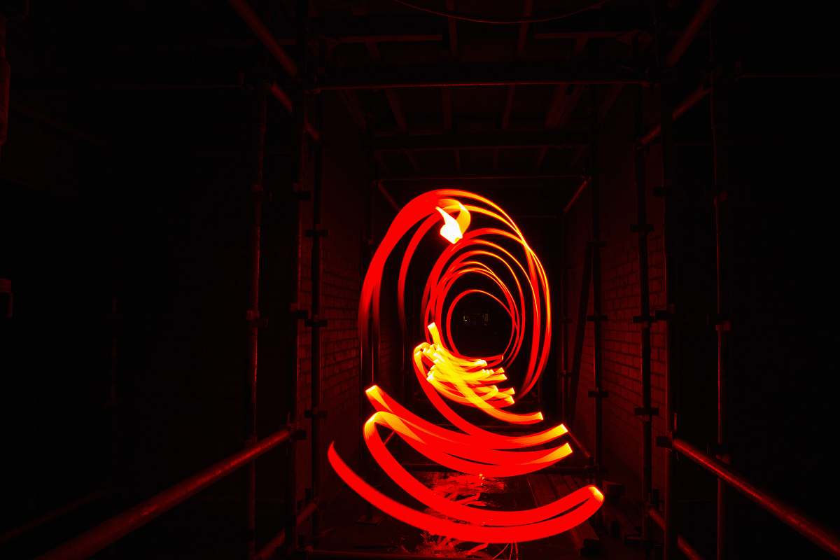 circle time-lapsed photo of red and yellow light mouvement