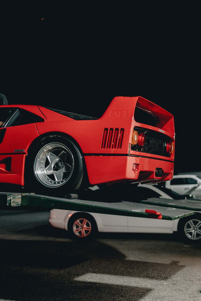 wheel red sports car parked on truck tire