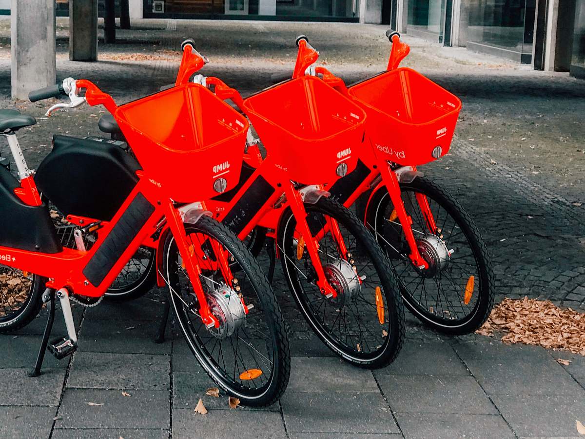 wheel three bicycles parked near post bicycle