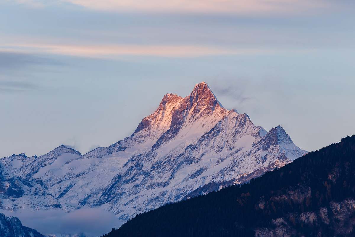 peak white and black mountains covered by snow under blue sky at daytime switzerland