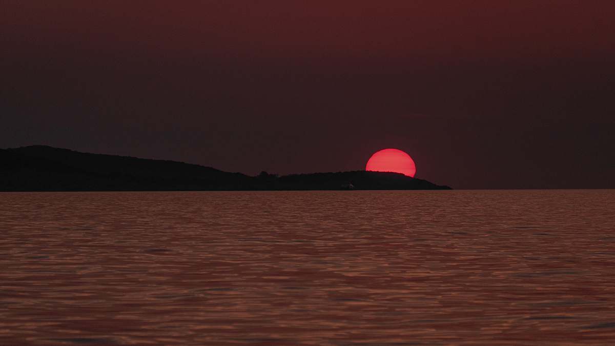 outdoors body of water viewing mountain during sunset sun