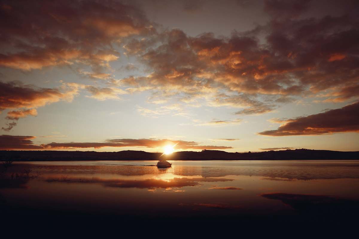 outdoors calm body of water during golden hour sky