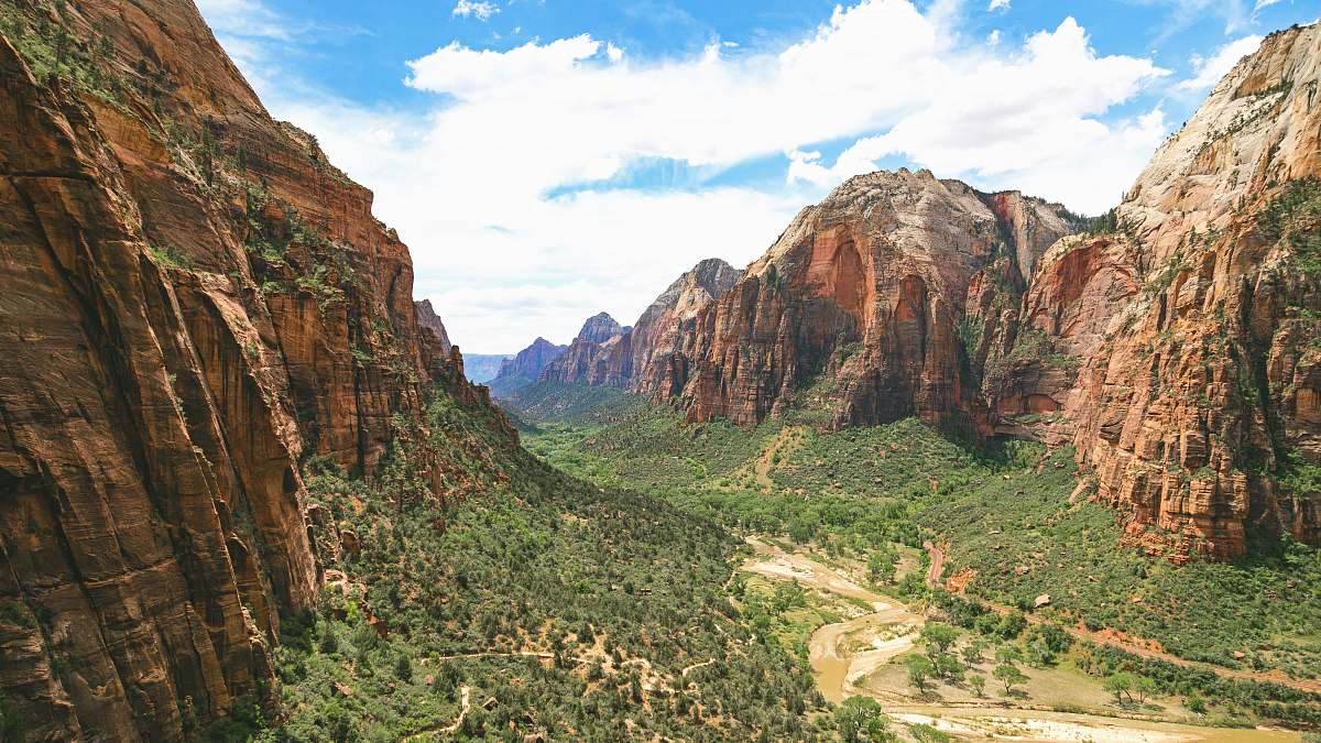 mountain green plants and trees between brown cliff during daytime valley