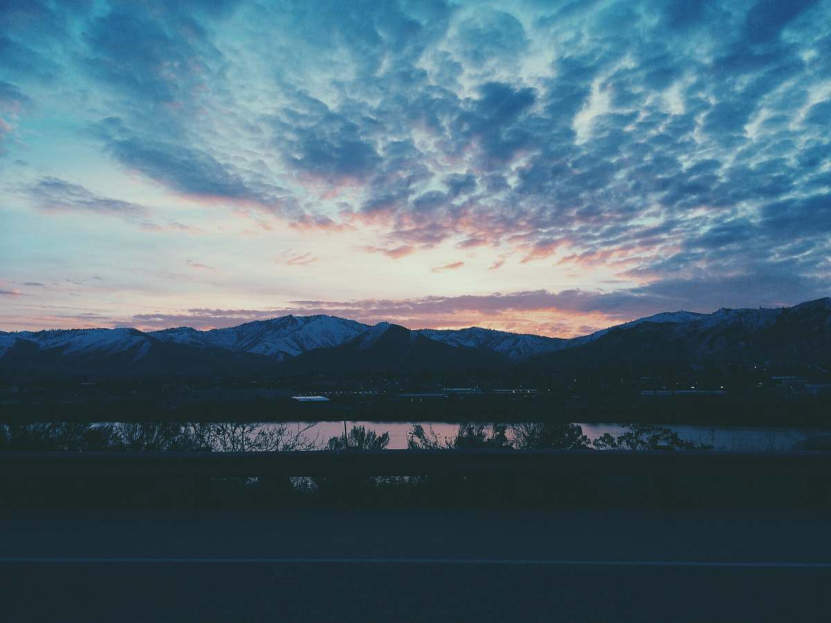 dawn mountain near body of water under white and blue sky during nighttime photography dusk