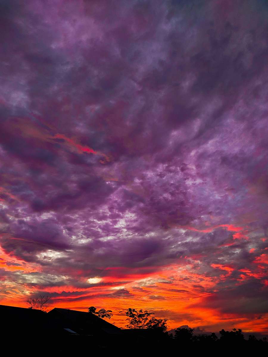 sky silhouette of mountain under purple and orange skies outdoors