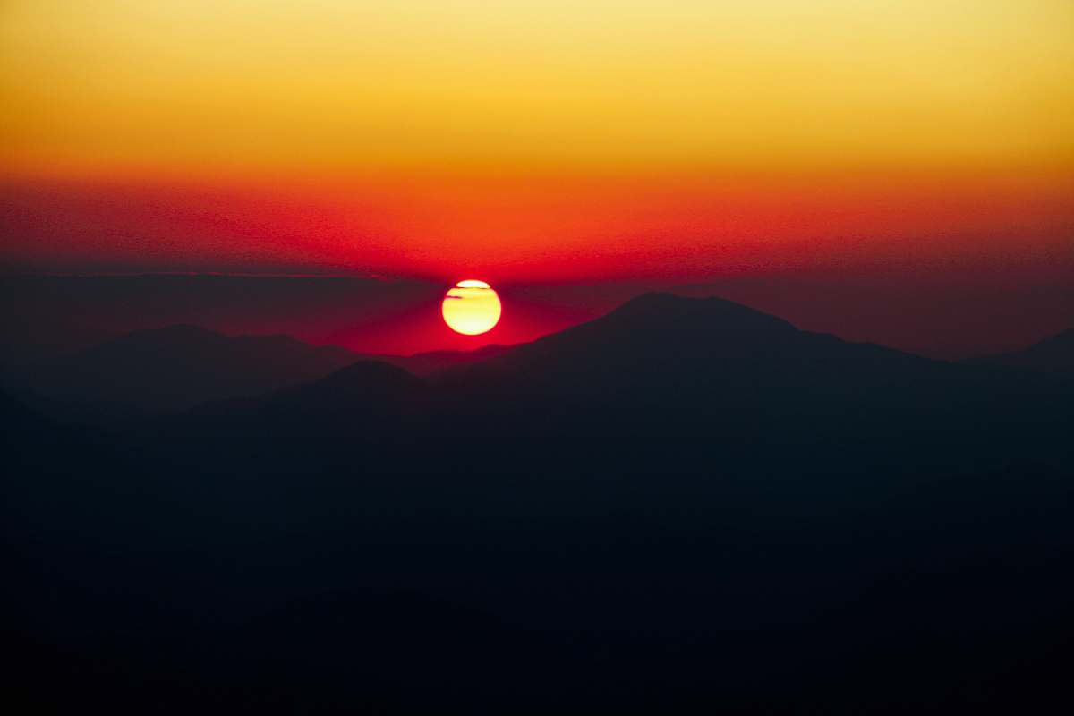 outdoors silhouette of mountains and orange sky sun