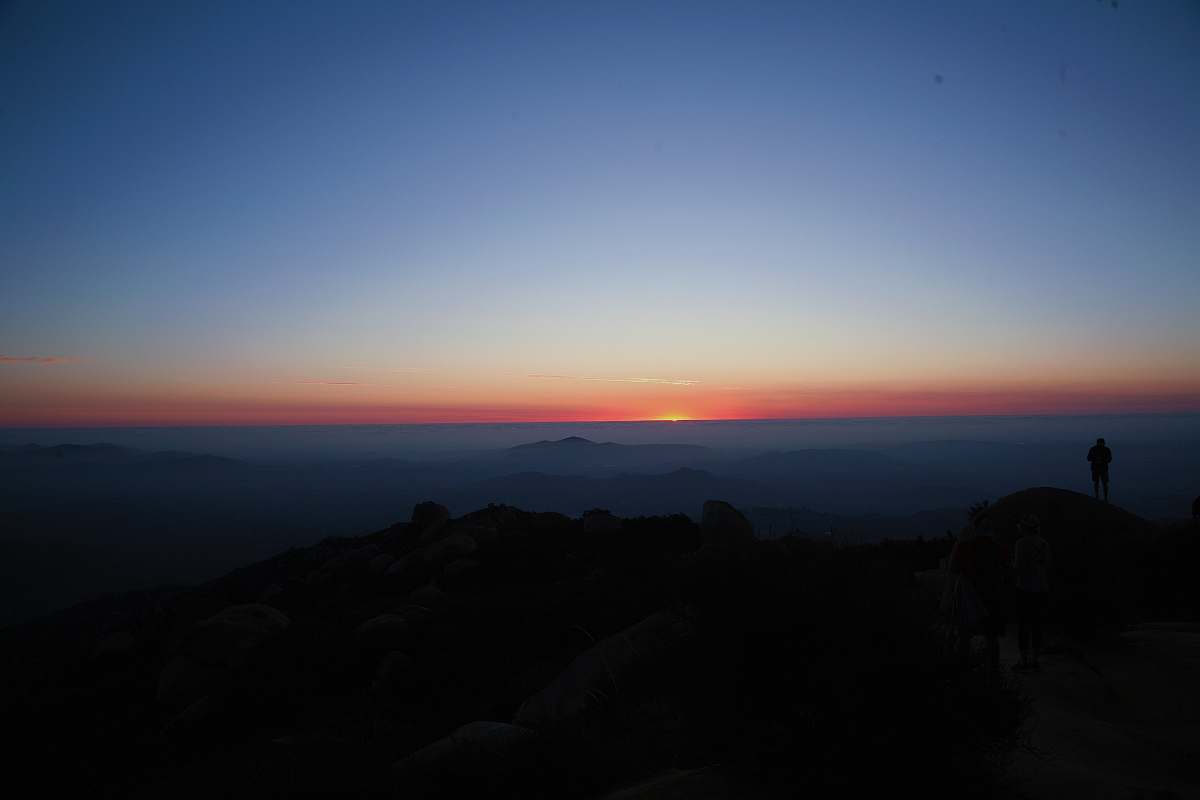 sky silhouette of person standing on cliff sunset