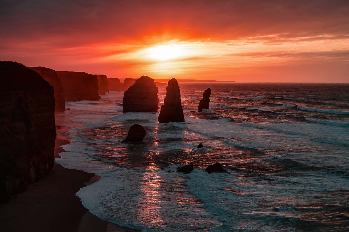 australia silhouette of stone on seashore during golden hour sunset