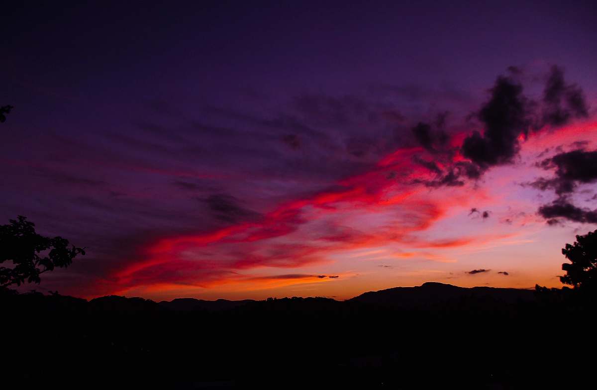 sunset silhouette of trees and mountains during sunset sky