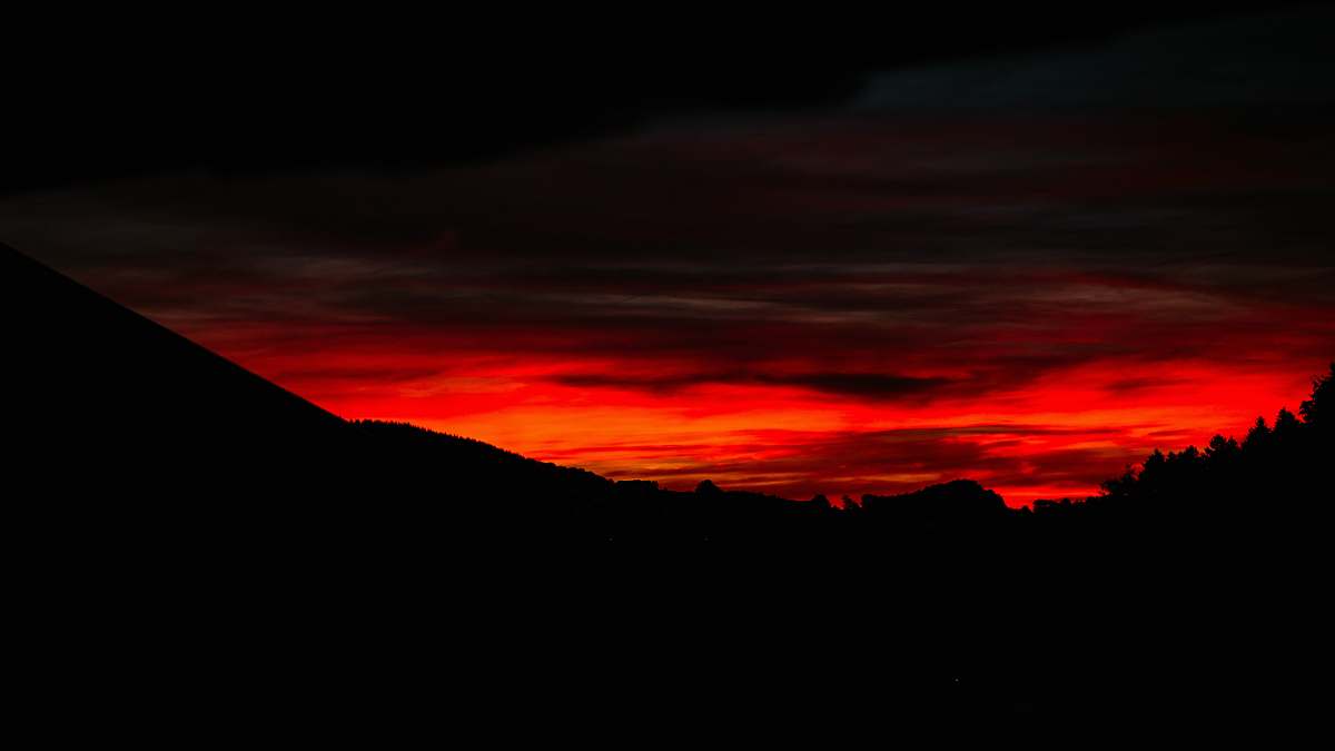 sunset silhouette photography of hills sky