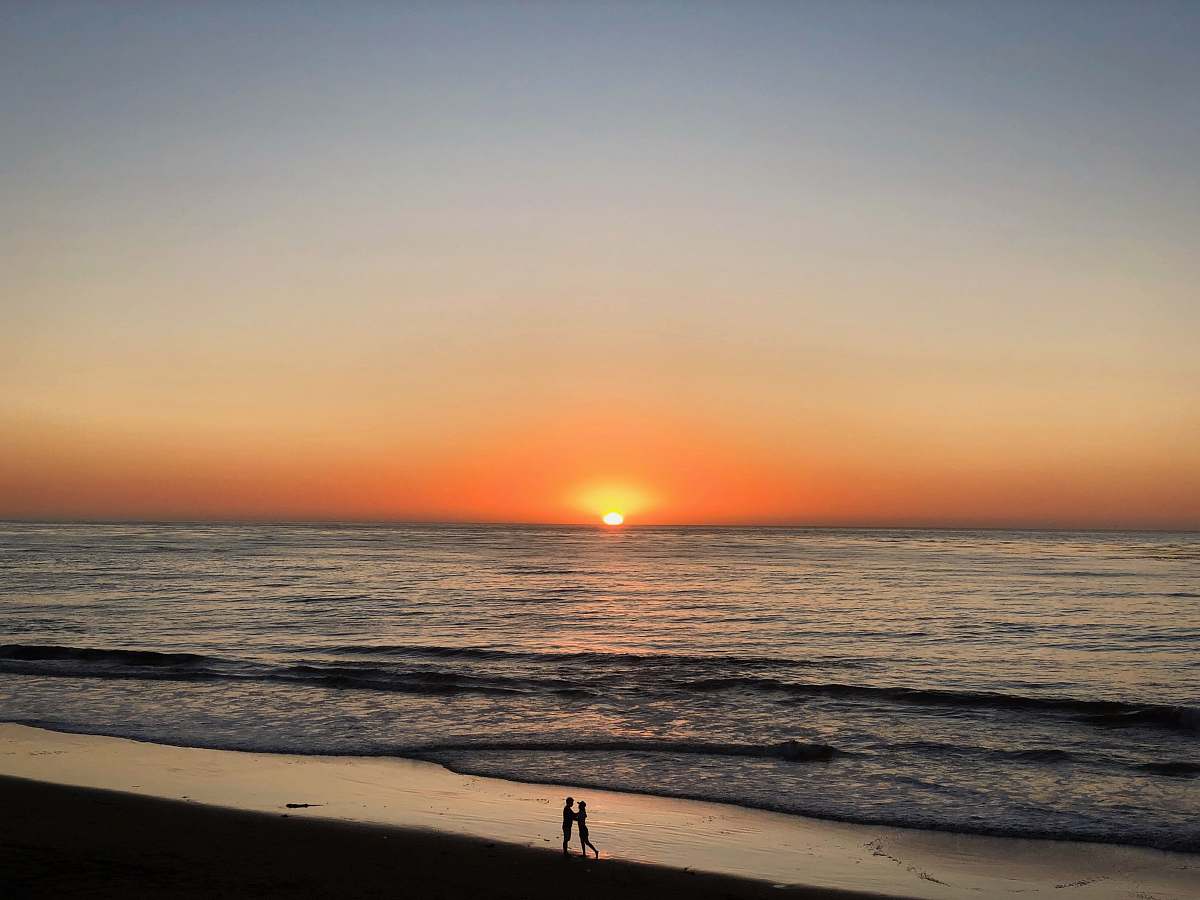 outdoors two people standing in seashore sky