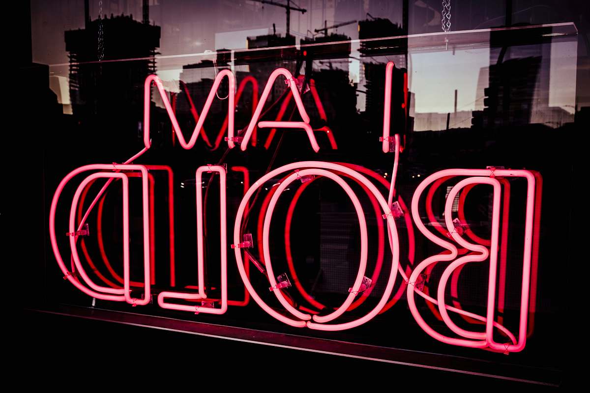 sign I Am bold neon signage at night time words