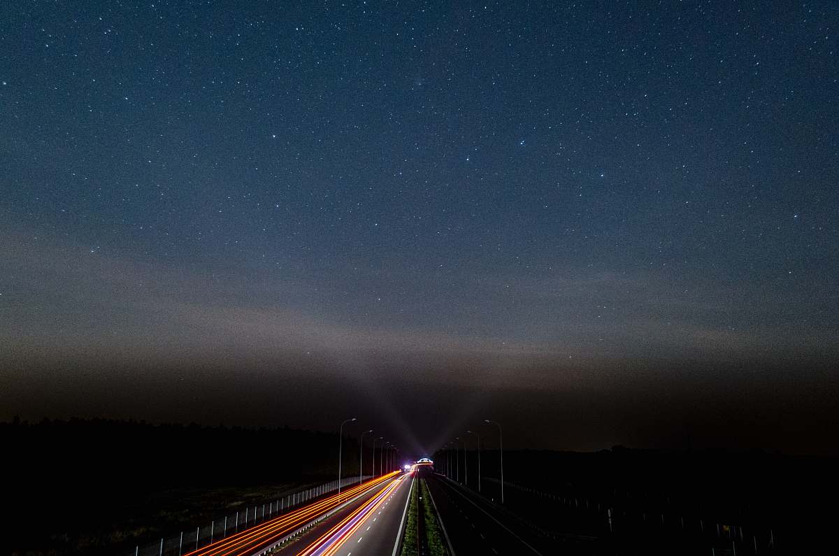 sky vehicles on road during night time stars
