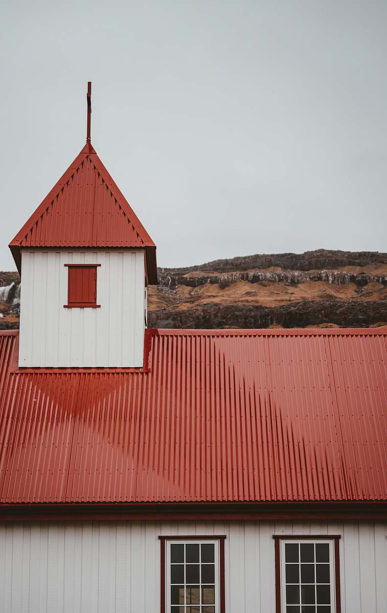 roof red and white building under cloudy sky during daytime window