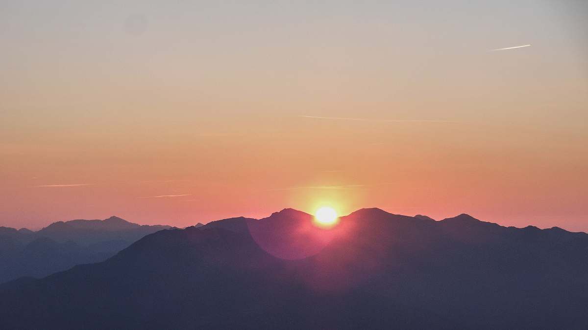 sunset silhouette photo of mountain during dawn sunrise