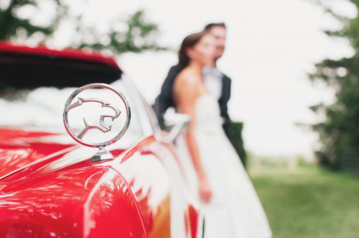human shallow focus photography of Jaguar car emblem wedding