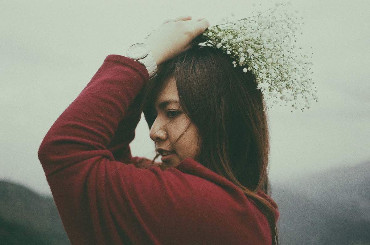 person shallow focus photography of woman holding flower bouquet human