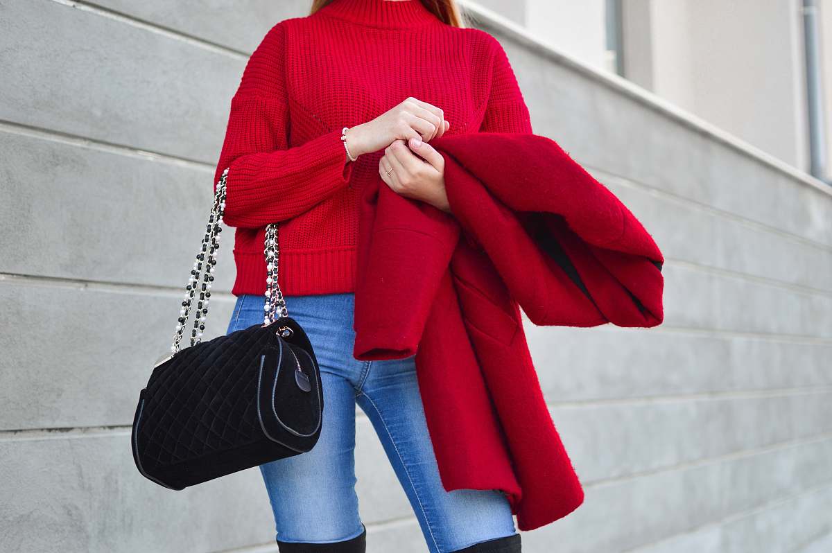 human woman in red sweater beside white wall person