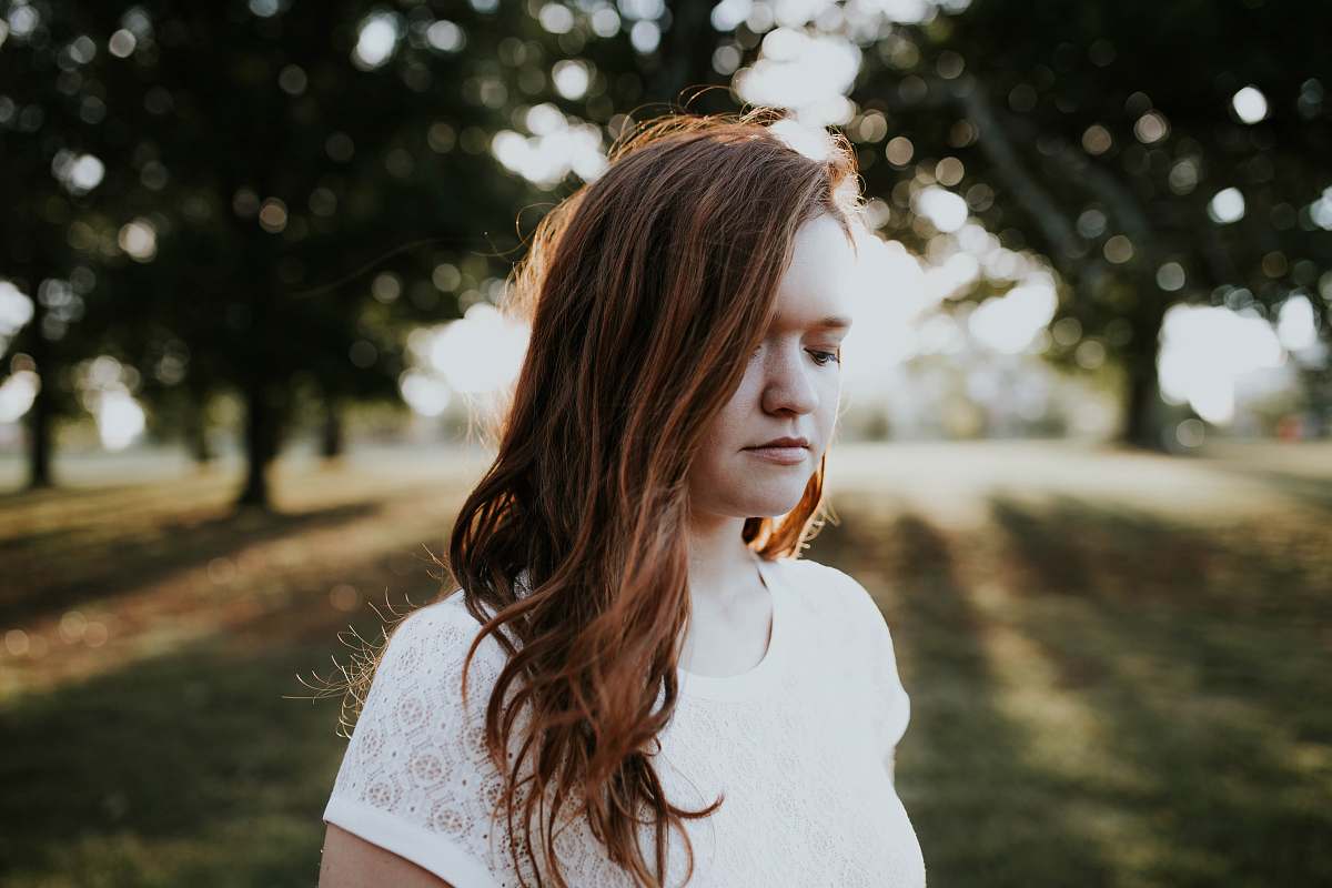 girl woman standing near trees during daytime woman