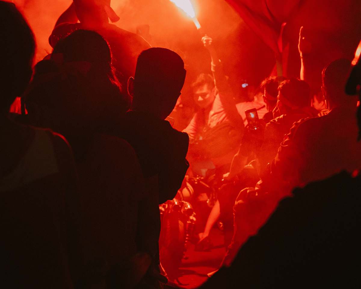 human group of people standing and racing their hands crowd