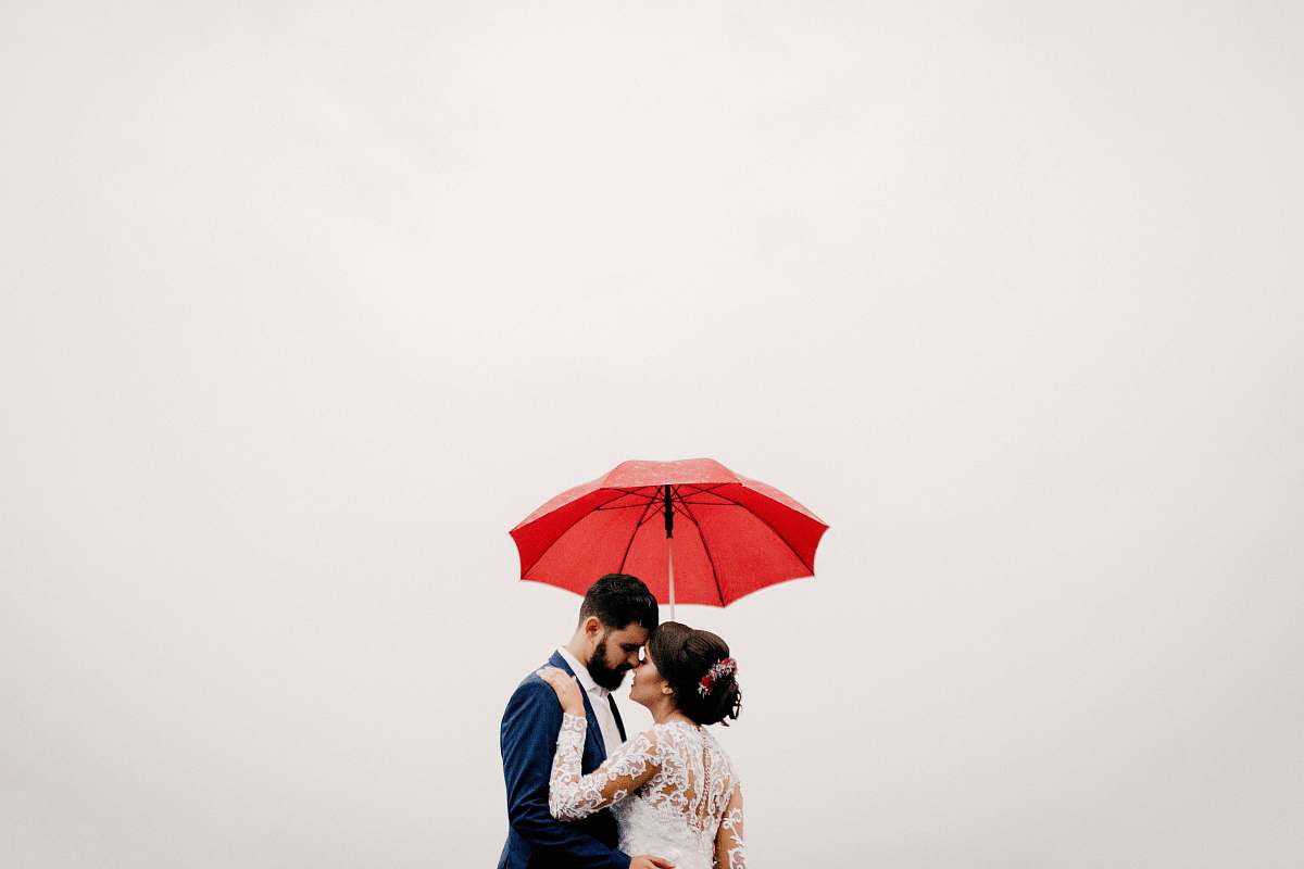 red man and woman under red umbrella human