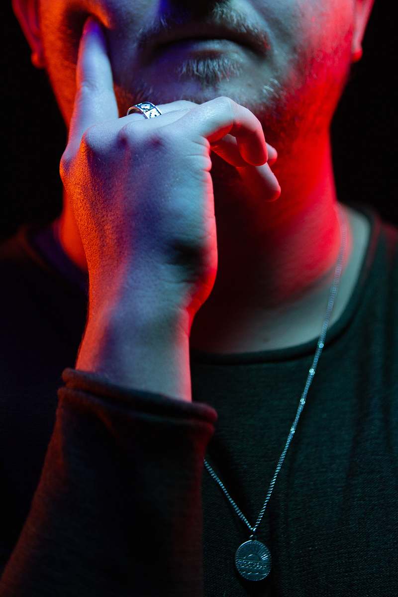 human man putting his finger on chick wearing silver-colored necklace people
