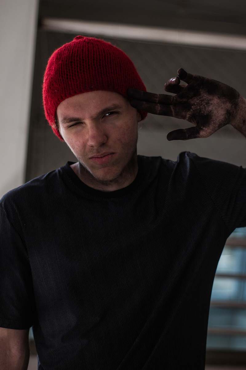 people man wearing black crew-neck t-shirt pointing his head human