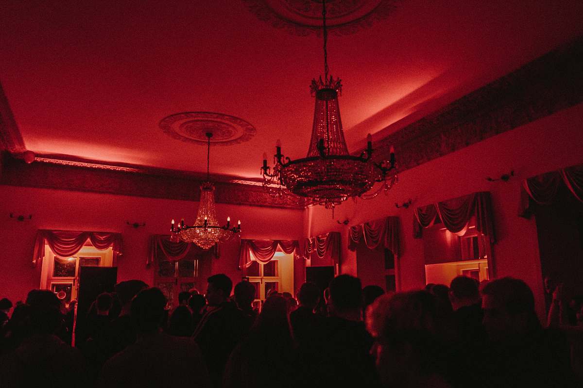 human people sitting on table near black and white chandelier lamp