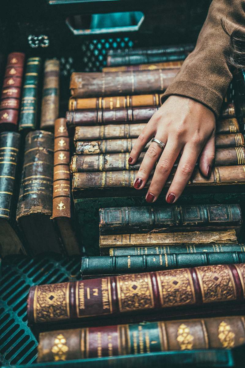 human person hand on group of books book