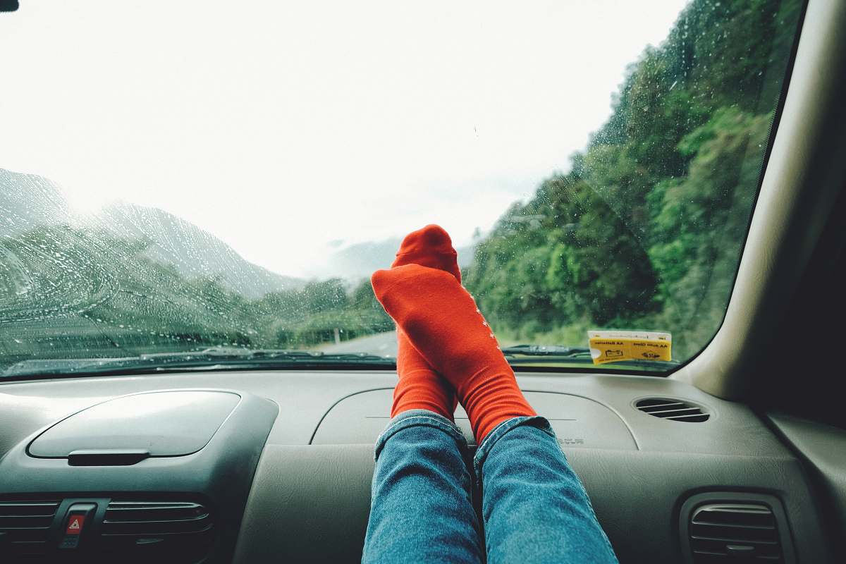 car person wearing red socks near mountain vehicle