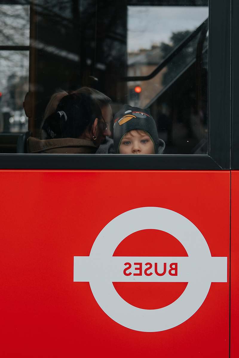 human photo of child riding in bus people