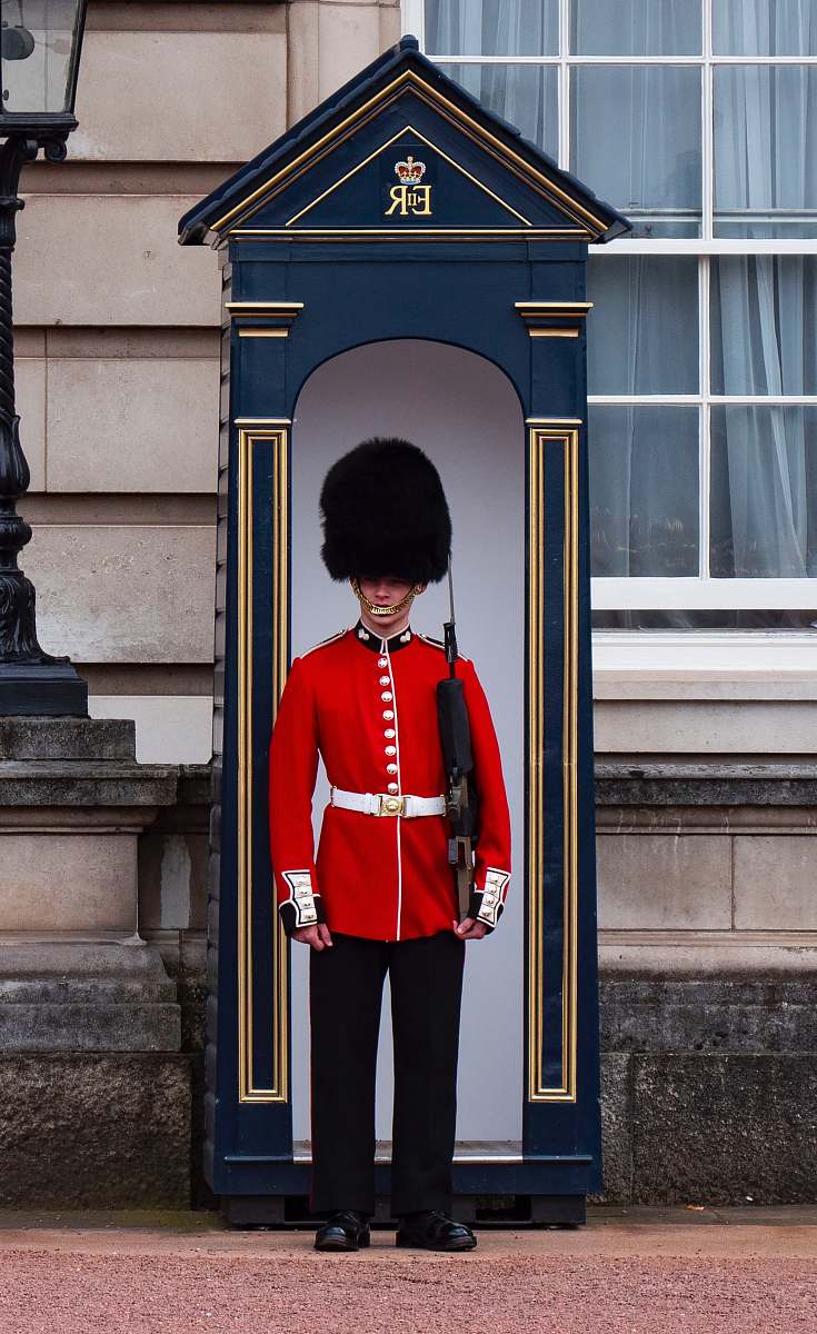 military Royal Guard standing near post military uniform