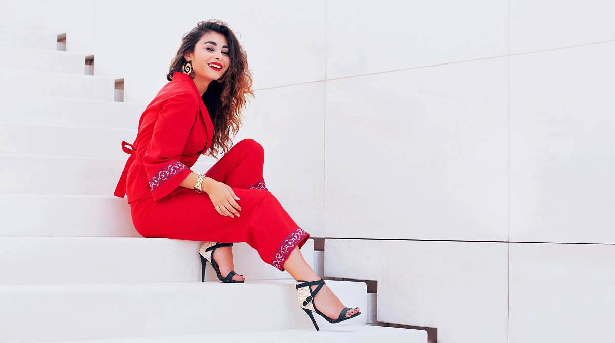 apparel smiling woman sits on stairway clothing