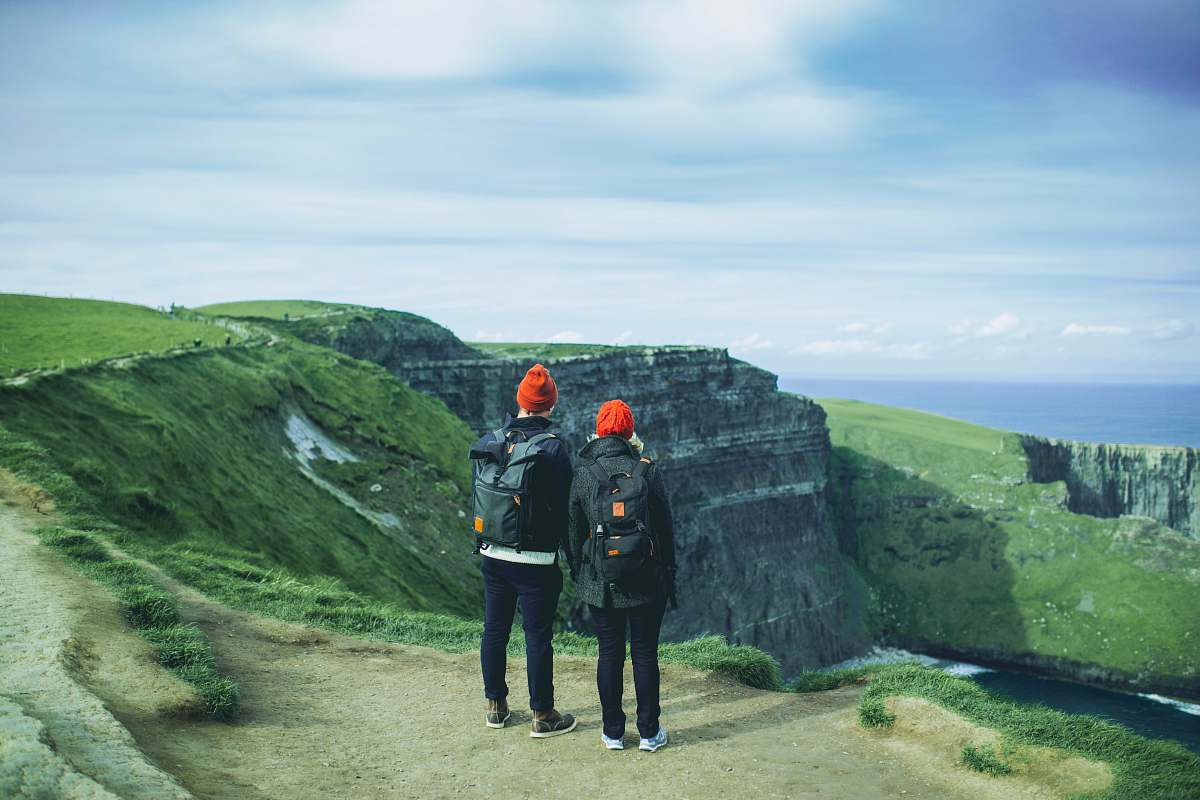 human two person looking on mountain cliff near river people
