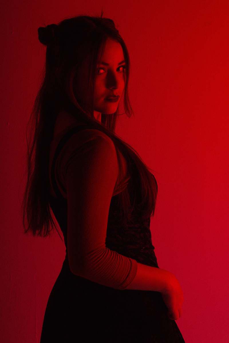 human woman in black sleeveless dress low-light photography people