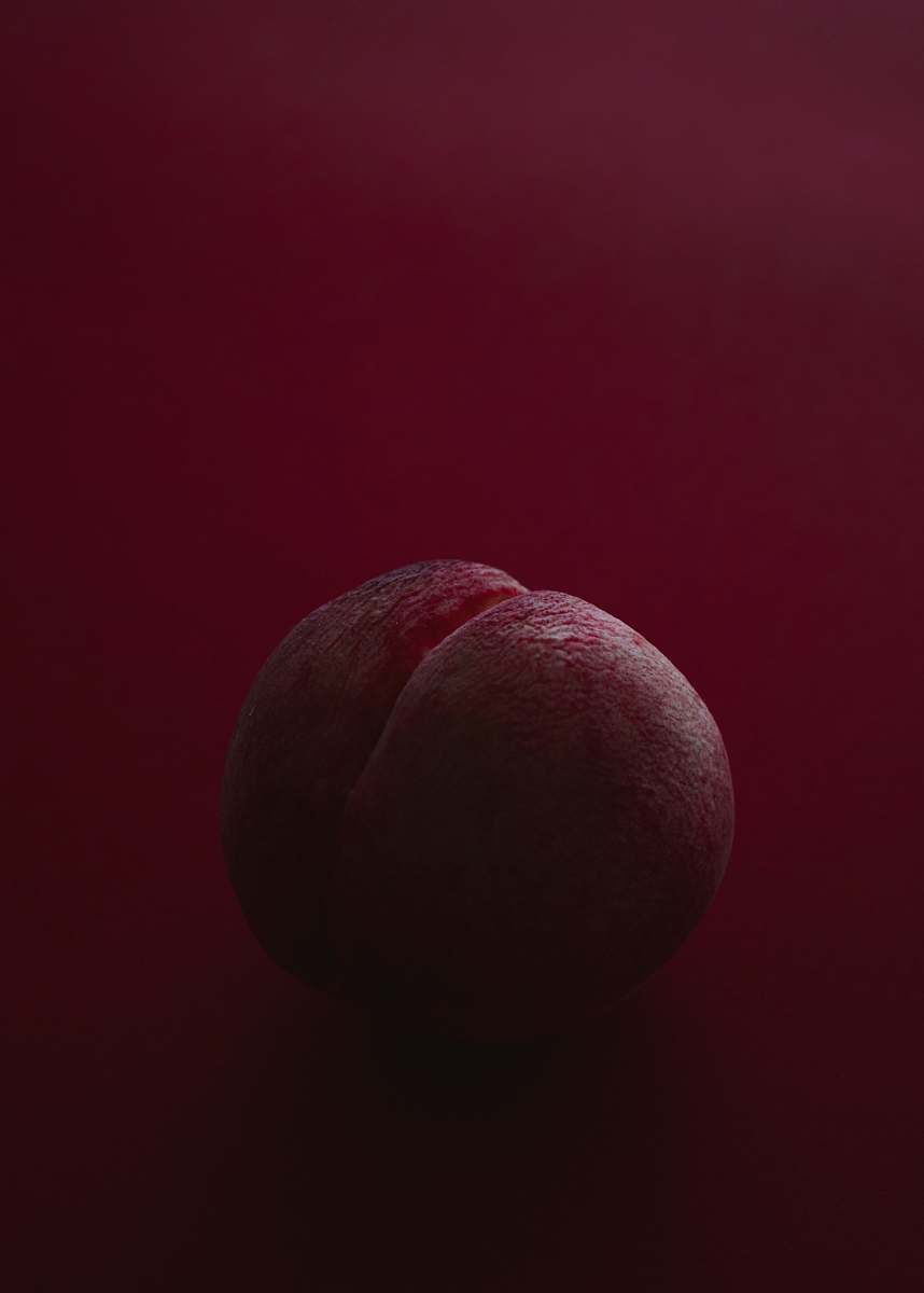 fruit brown ball on red surface food