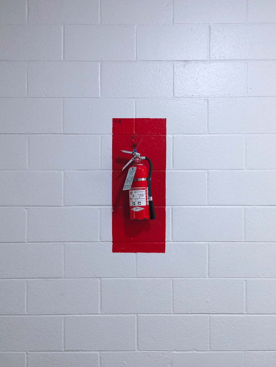 or red fire extinguisher on wall usa