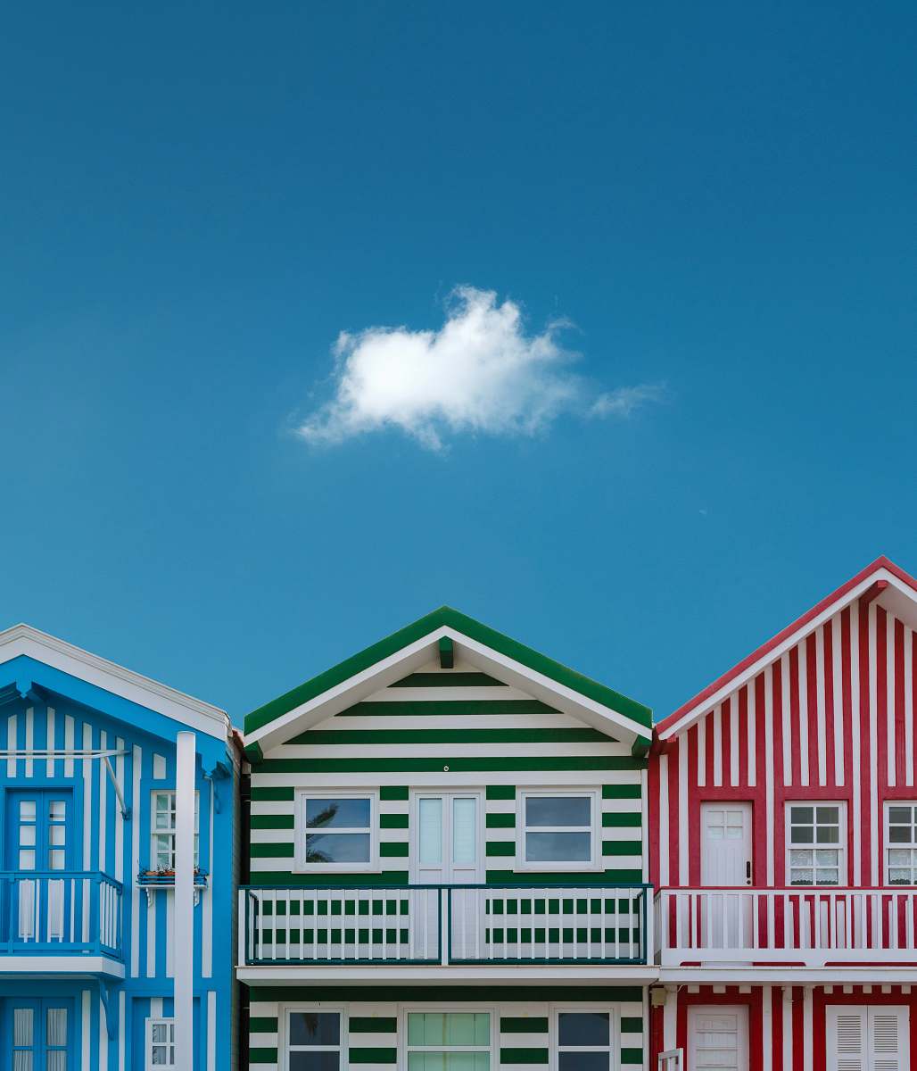 blue three assorted-color houses next to each other building