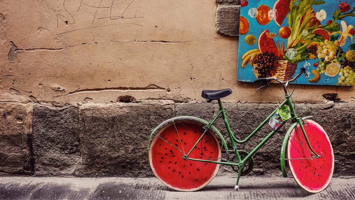italy bicycle beside wall watermelon