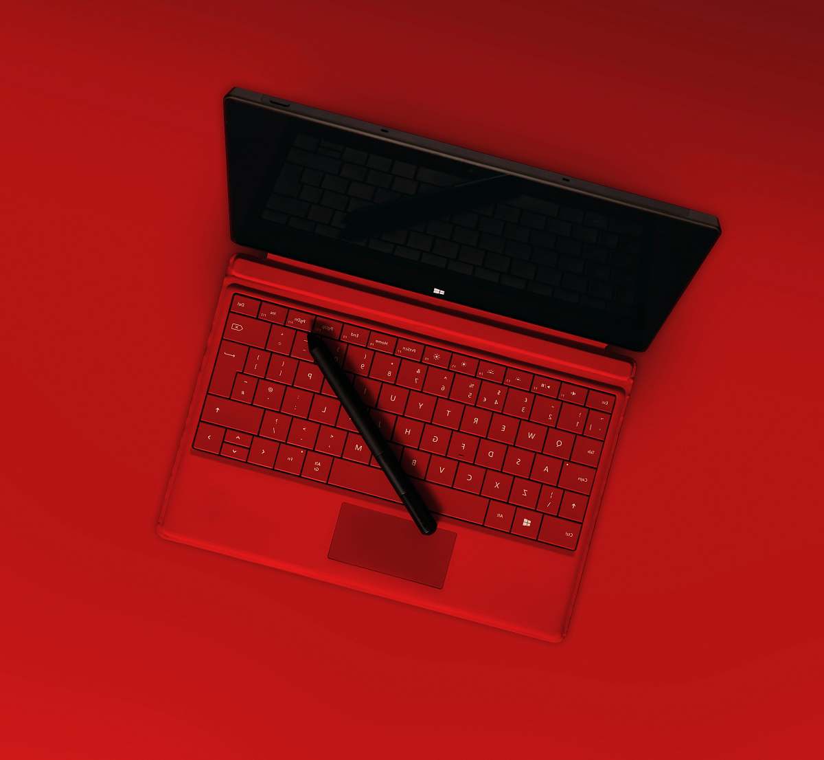 tablet black pen on red laptop computer keyboard