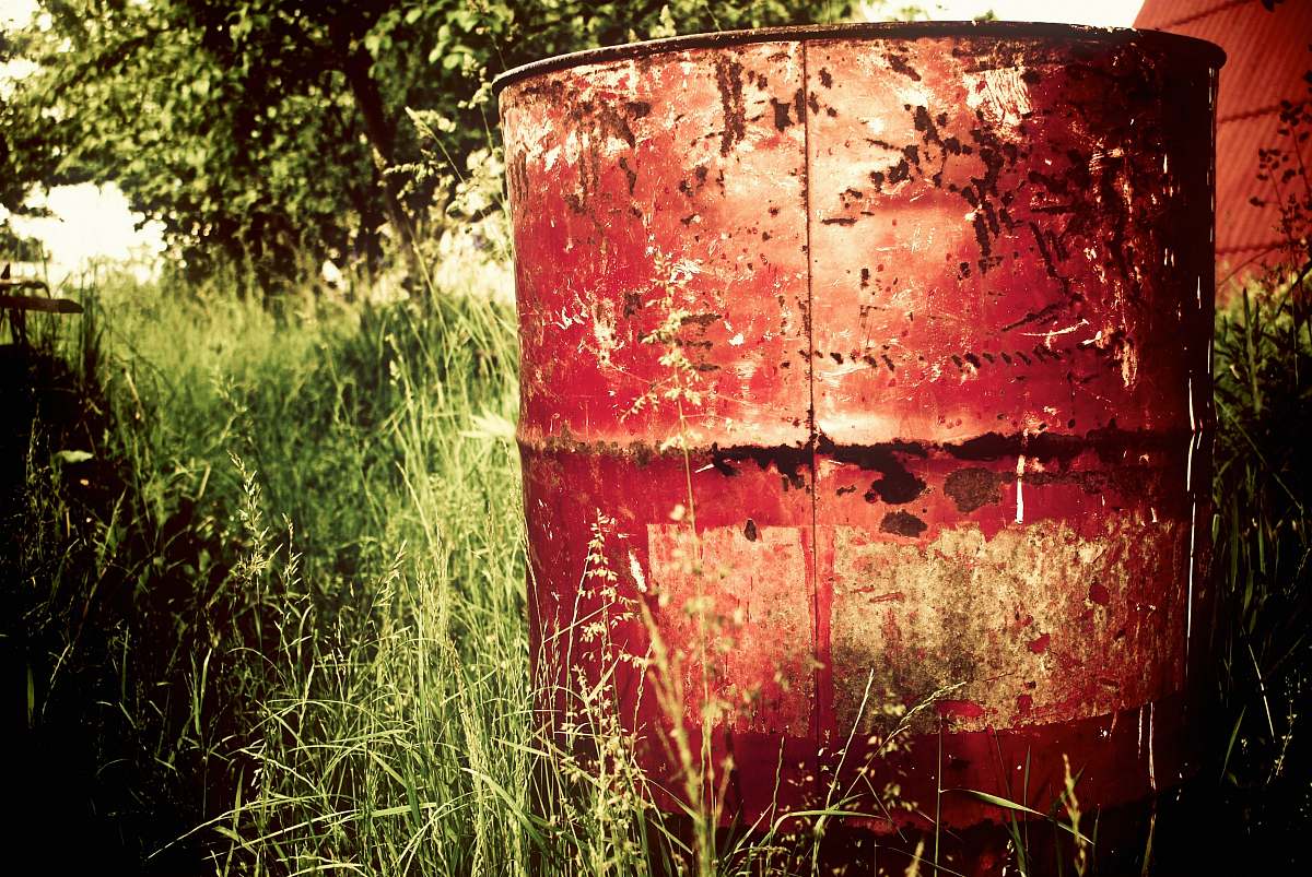 grass brown metal barrel on grass field green