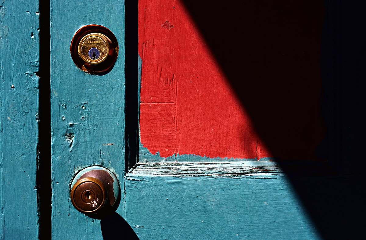 handle closed teal wooden door with brass-colored door knob door