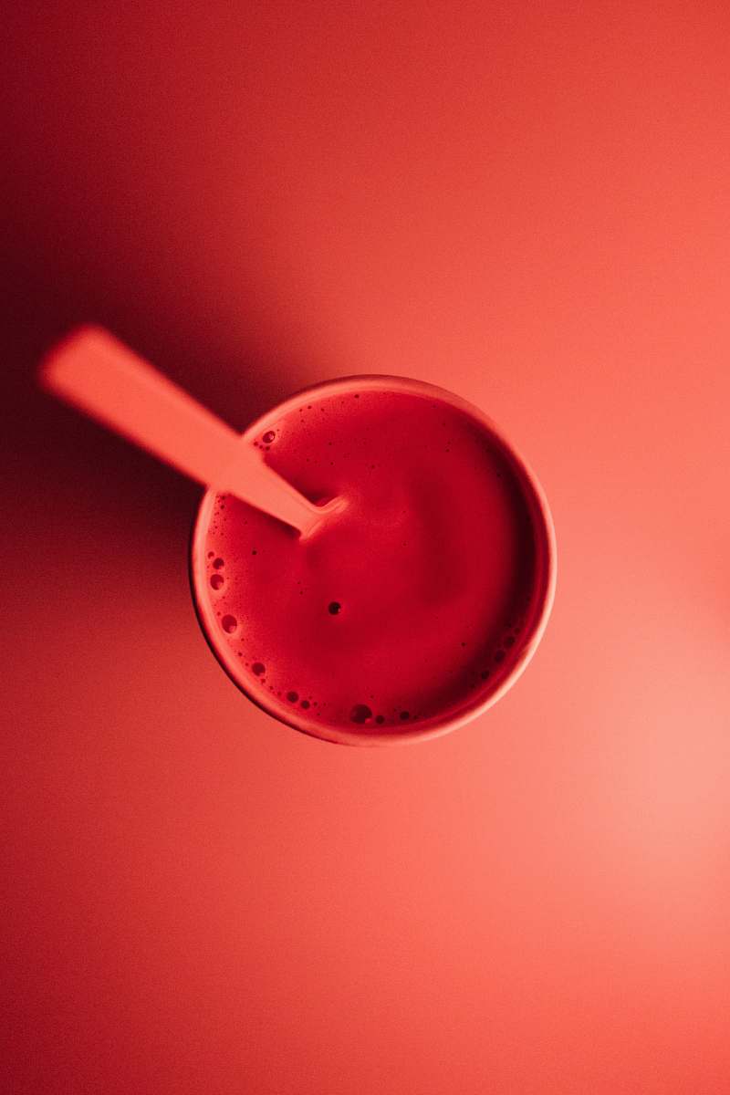 food cup with brown liquid and spoon color