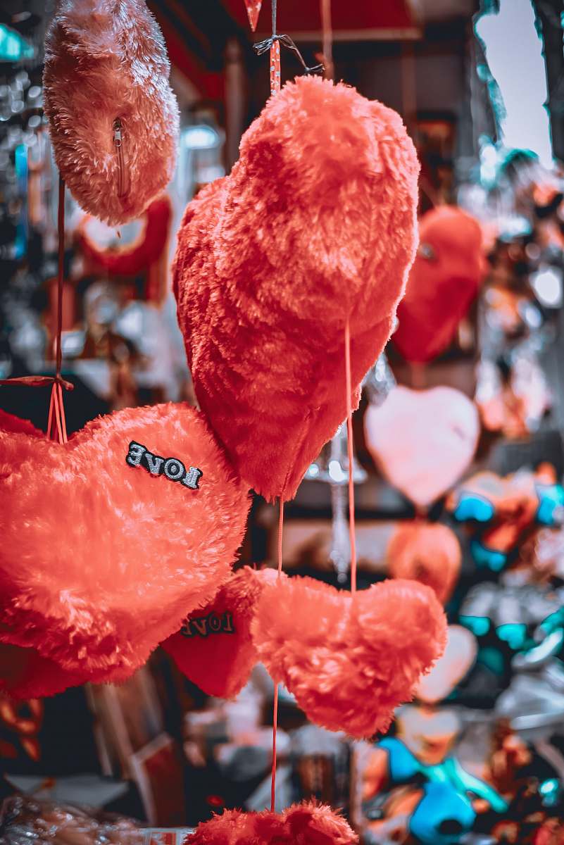 human hanging red heart plush toys person