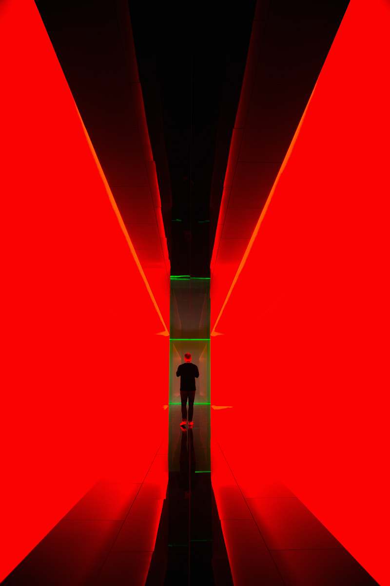 lighting man between red light hallway light