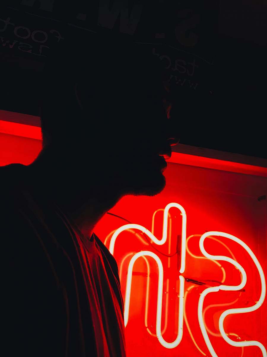 auburn man in front of red SH neon signage united states